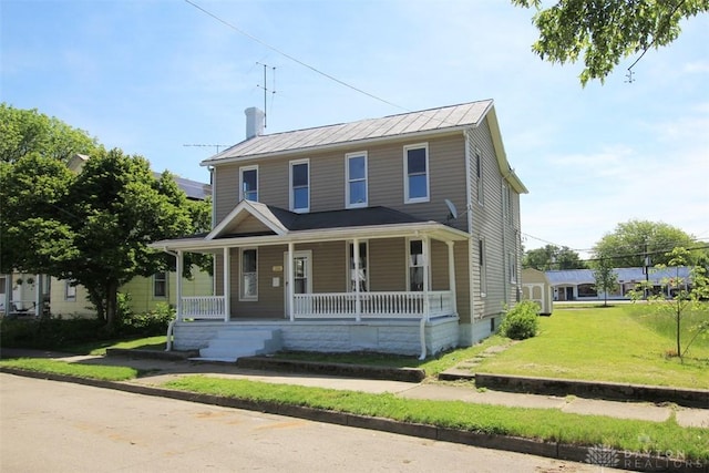 224 Suttman St, Miamisburg, OH 45342 - view of front facade with covered porch, a front yard, a chimney, and metal roof