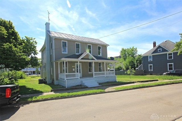 224 Suttman St, Miamisburg, OH 45342 - view of front of home with covered porch, a standing seam roof, a chimney, a front yard, and central AC