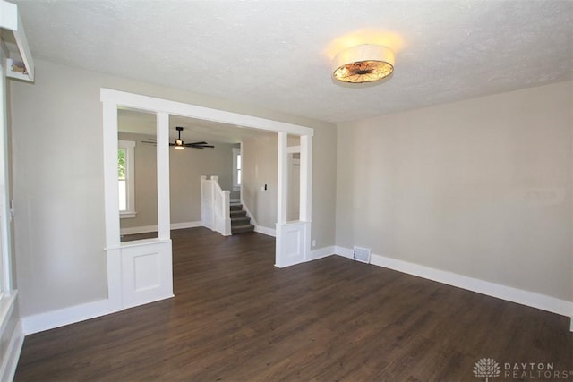 224 Suttman St, Miamisburg, OH 45342 - unfurnished room with dark wood-style floors, stairs, baseboards, a textured ceiling, and ceiling fan