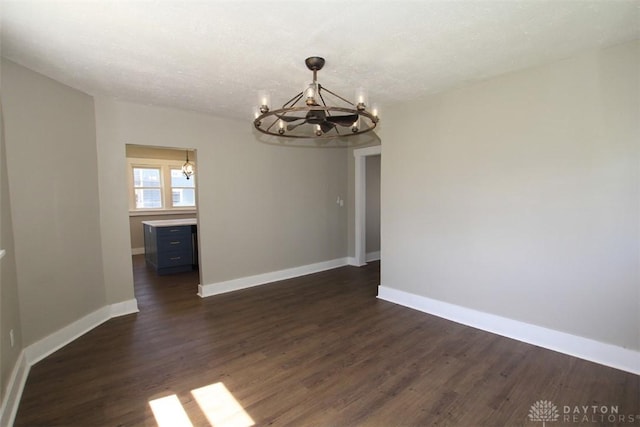 224 Suttman St, Miamisburg, OH 45342 - unfurnished dining area featuring a chandelier, dark wood-style floors, and baseboards