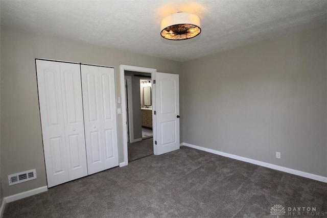 224 Suttman St, Miamisburg, OH 45342 - unfurnished bedroom featuring dark colored carpet, baseboards, a closet, and a textured ceiling