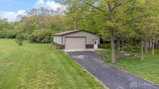 view of front facade with a garage, an outbuilding, and a front yard