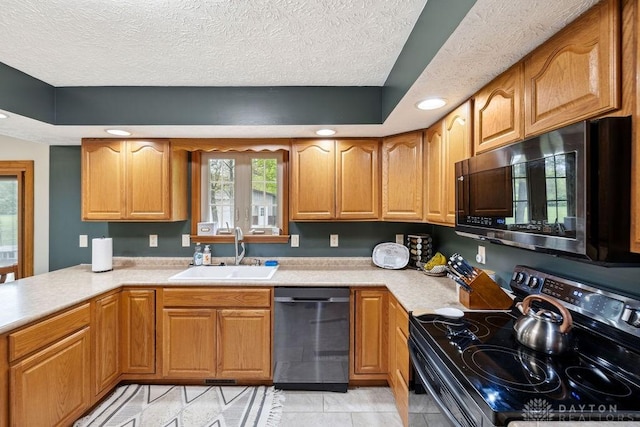 kitchen with electric stove, a sink, dishwasher, light countertops, and a textured ceiling