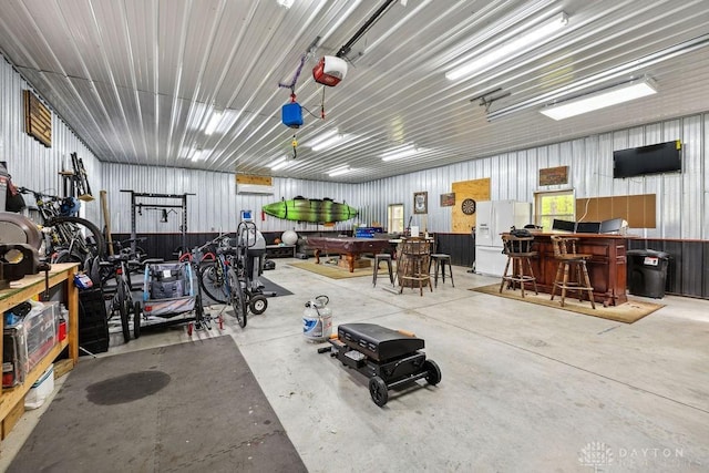 garage with white fridge with ice dispenser and a garage door opener