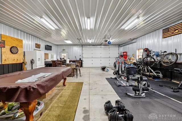 garage featuring white refrigerator with ice dispenser