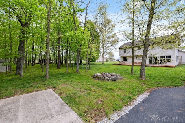 view of green lawn with a deck