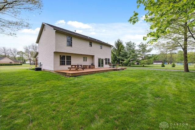 back of house featuring a deck, a yard, and cooling unit