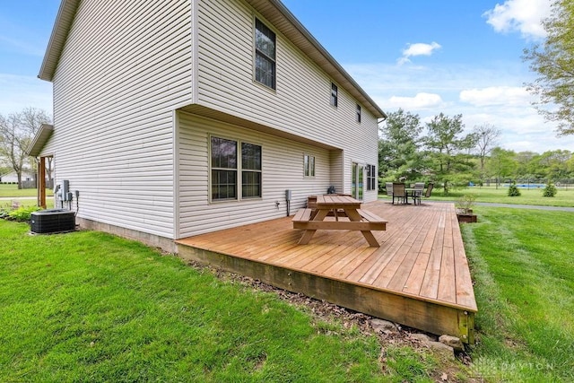 rear view of property with outdoor dining area, a wooden deck, a yard, and central AC unit