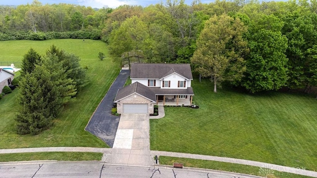 view from above of property with a heavily wooded area