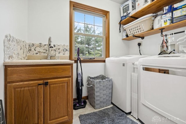washroom with independent washer and dryer and cabinet space