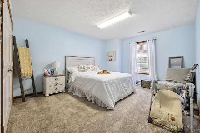 carpeted bedroom featuring a textured ceiling