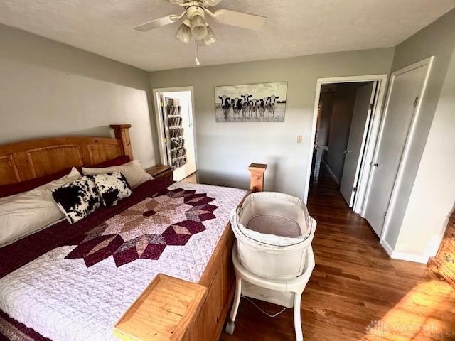 bedroom featuring wood finished floors, a ceiling fan, and baseboards