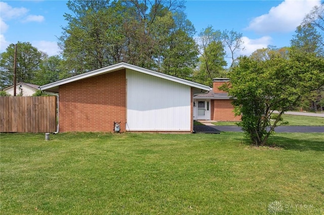 view of side of home featuring brick siding