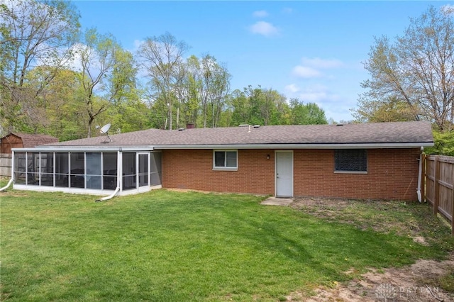 back of house featuring a sunroom, brick siding, and roof with shingles