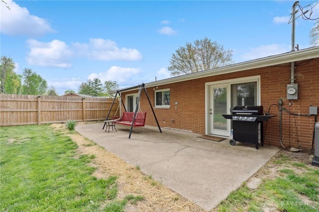 back of house with a patio area and brick siding