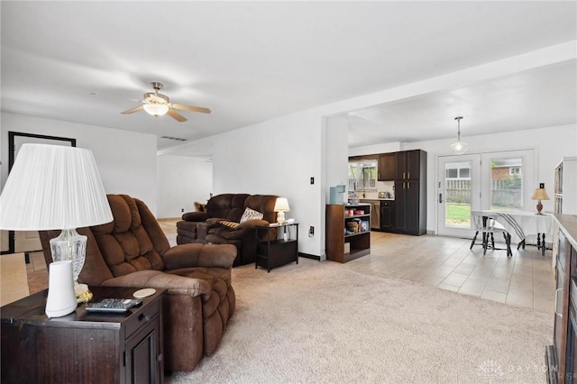 living room featuring a ceiling fan and light colored carpet