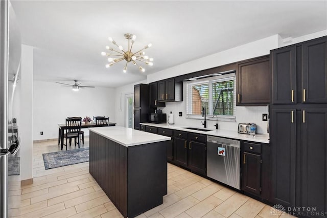 kitchen with a sink, appliances with stainless steel finishes, a chandelier, light countertops, and ceiling fan