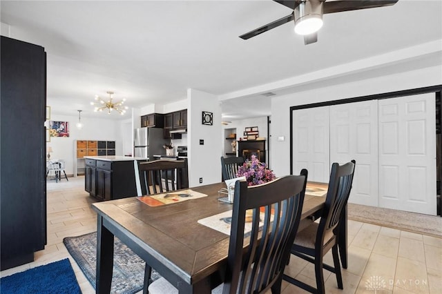 dining space featuring a chandelier and ceiling fan