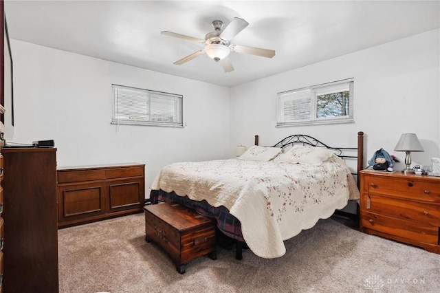 bedroom featuring light carpet and ceiling fan