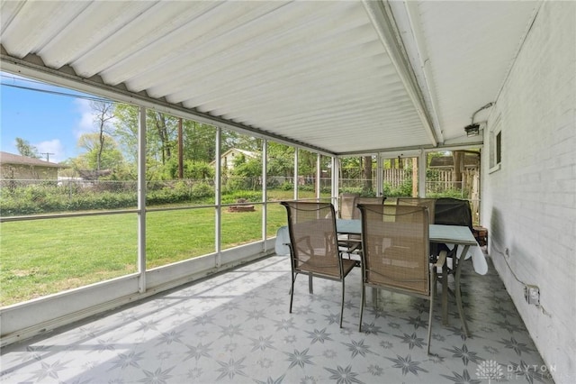 sunroom / solarium featuring outdoor dining area