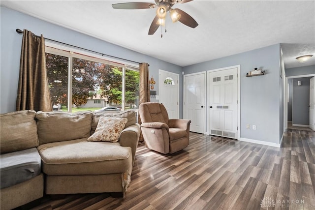 living room with a ceiling fan, wood finished floors, and baseboards