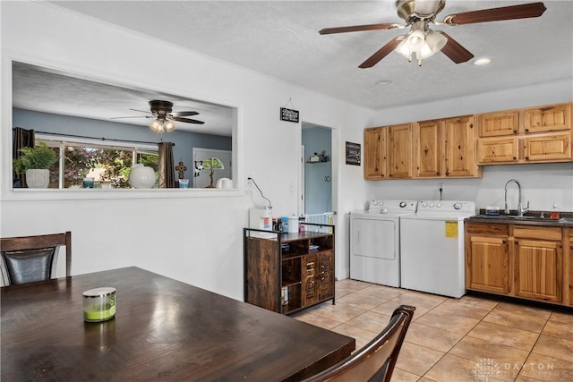 laundry room with washing machine and dryer, cabinet space, ceiling fan, light tile patterned floors, and a textured ceiling