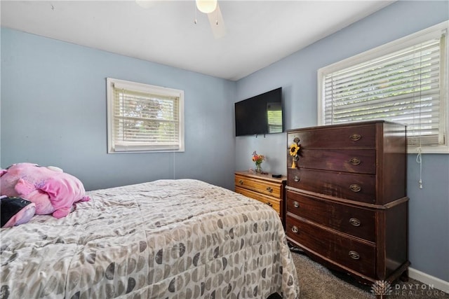 bedroom with multiple windows, carpet flooring, and a ceiling fan