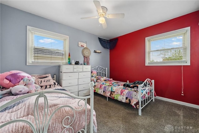 carpeted bedroom featuring multiple windows and ceiling fan