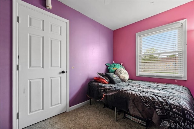 bedroom with carpet and baseboards
