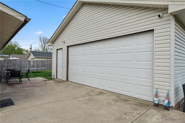 garage with a trampoline and fence