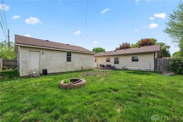 rear view of house with an outdoor fire pit and a patio area