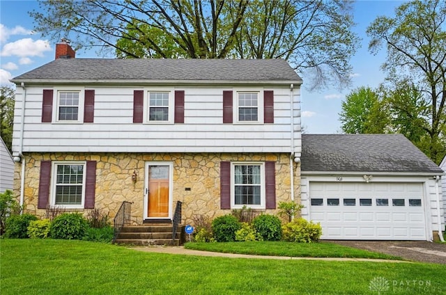 504 Dover Rd, Springfield, OH 45504 - colonial house with stone siding, a chimney, a garage, and asphalt driveway