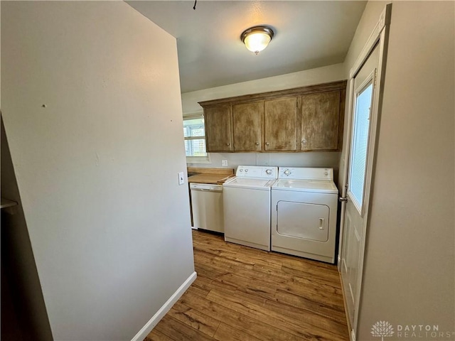 4832 Barnhart Ave, Dayton, OH 45432 - laundry room with cabinet space, washing machine and clothes dryer, wood finished floors, and baseboards