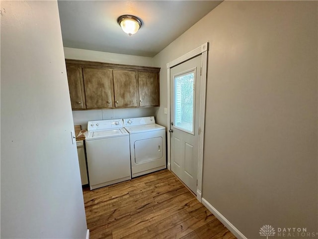 4832 Barnhart Ave, Dayton, OH 45432 - laundry room featuring washer and dryer, wood finished floors, cabinet space, and baseboards