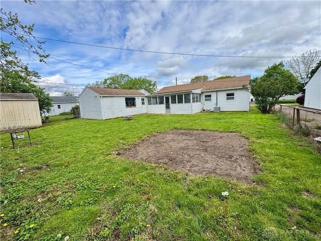 4832 Barnhart Ave, Dayton, OH 45432 - back of house featuring an outdoor structure, a sunroom, and a shed