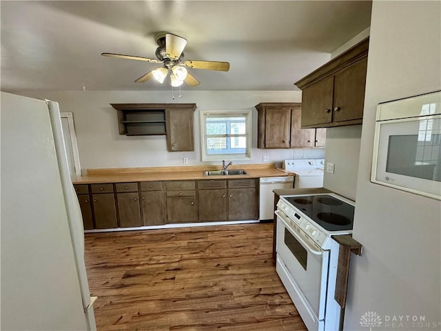 4832 Barnhart Ave, Dayton, OH 45432 - kitchen with white appliances, a sink, washer / dryer, dark wood-style flooring, and ceiling fan