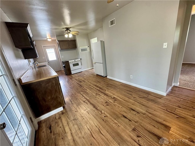 4832 Barnhart Ave, Dayton, OH 45432 - kitchen featuring white appliances, ceiling fan, hardwood / wood-style flooring, and dark brown cabinetry