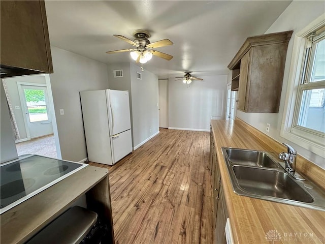 4832 Barnhart Ave, Dayton, OH 45432 - kitchen featuring freestanding refrigerator, a sink, butcher block countertops, a ceiling fan, and wood finished floors