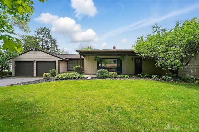 21 Hedgely Rd, Springfield, OH 45506 - view of front of property with an attached garage, driveway, a front yard, and a chimney