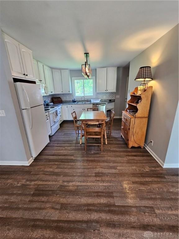 390 W Hendricks St, Camden, OH 45311 - kitchen with white appliances, a sink, decorative backsplash, and baseboards