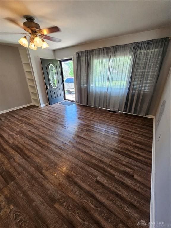 390 W Hendricks St, Camden, OH 45311 - unfurnished living room featuring wood finished floors, ceiling fan, and baseboards