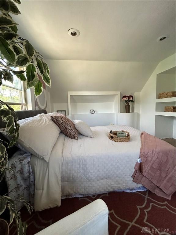 bedroom with lofted ceiling