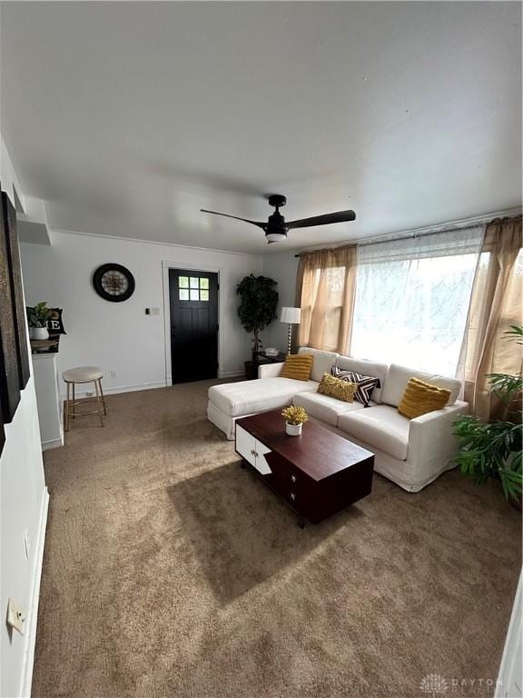 living room with carpet floors and a ceiling fan