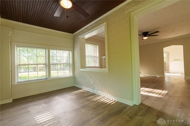2182 La Grange Rd, Beavercreek, OH 45431 - unfurnished room with ceiling fan, arched walkways, wood finished floors, crown molding, and baseboards