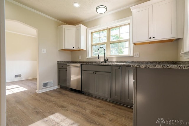 2182 La Grange Rd, Beavercreek, OH 45431 - kitchen with stainless steel dishwasher, crown molding, light wood-style floors, dark stone countertops, and white cabinets