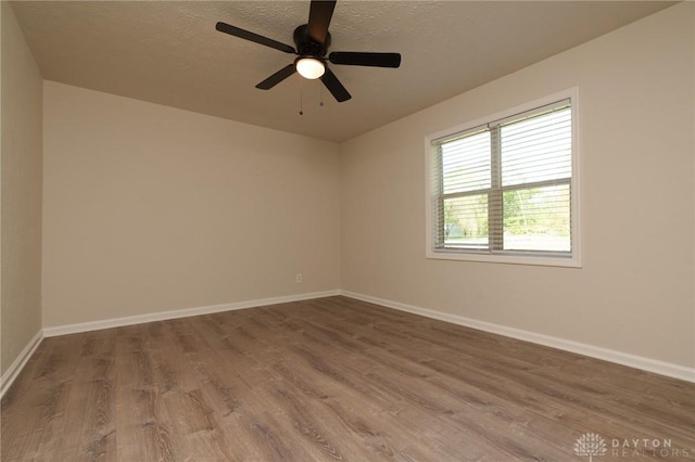 2182 La Grange Rd, Beavercreek, OH 45431 - unfurnished room featuring wood finished floors, baseboards, a textured ceiling, and ceiling fan