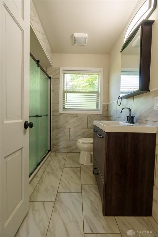2182 La Grange Rd, Beavercreek, OH 45431 - bathroom with tile walls, vanity, a shower, and marble finish flooring