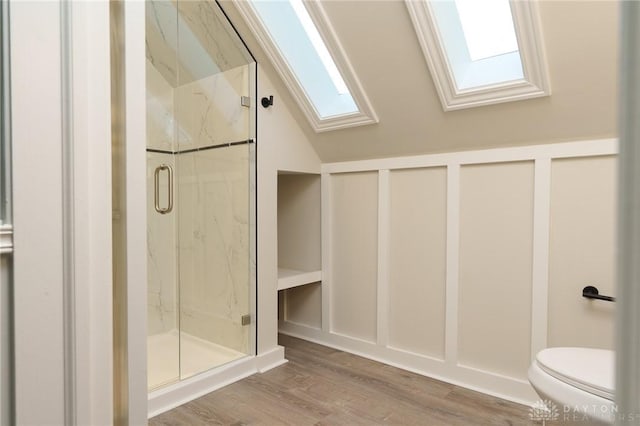 2182 La Grange Rd, Beavercreek, OH 45431 - bathroom featuring a skylight, a marble finish shower, wood finished floors, toilet, and vaulted ceiling