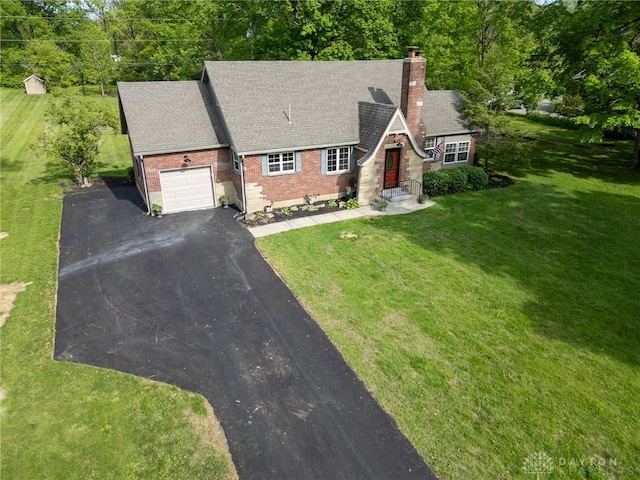2182 La Grange Rd, Beavercreek, OH 45431 - view of front of property with a garage, asphalt driveway, a chimney, brick siding, and a front yard