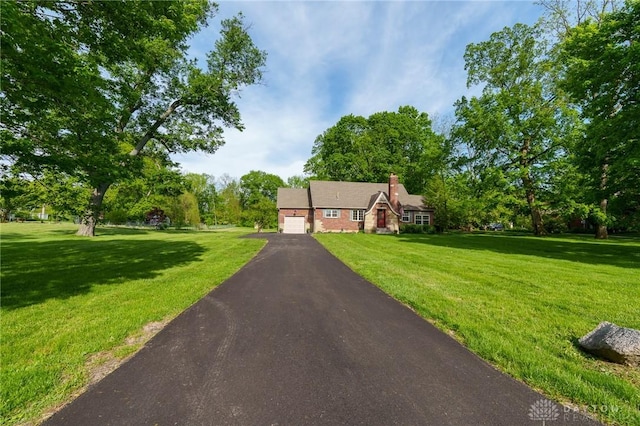 2182 La Grange Rd, Beavercreek, OH 45431 - view of front facade with an attached garage, a front yard, driveway, and a chimney